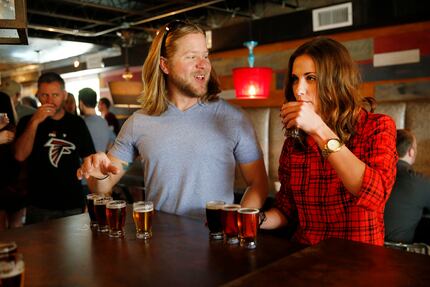 Ryan Bloom (left) and Ashley Taylor (right), both of Austin, Texas, try sample beers after a...