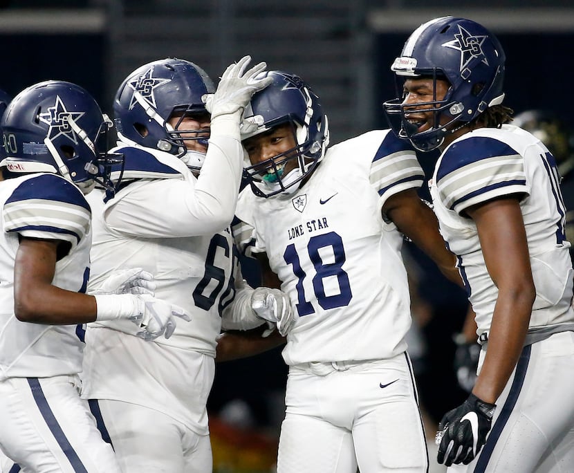 Frisco Lone Star's Marvin Mims (18) is congratulated by Reese Cory (66), Kavika Pittman (10)...