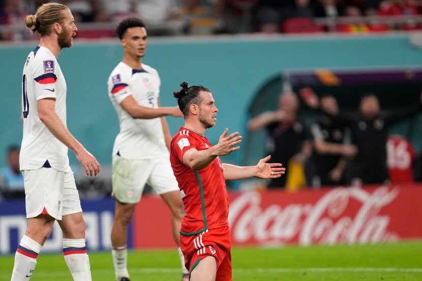 Wales' Gareth Bale reacts after a challenge during the World Cup, group B soccer match...