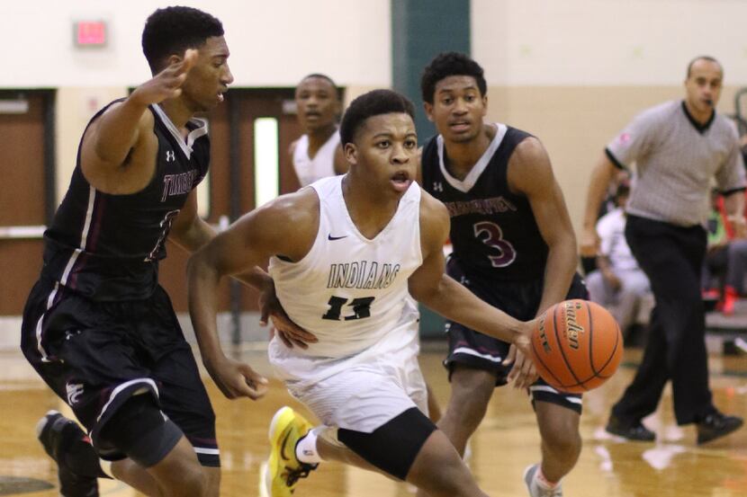 Waxahachie's Mar'Qualen Grant (13) splits the defense of Mansfield Timberview's Rossi Paul...