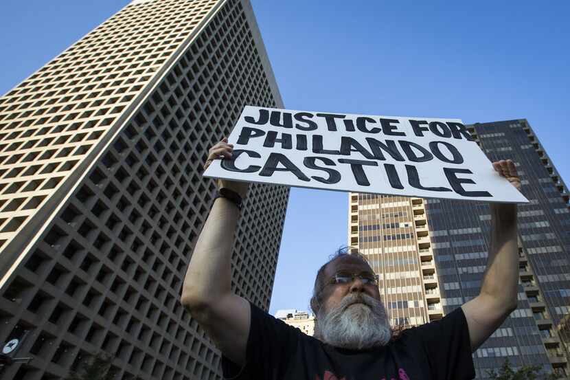 John Fullinwider held a sign as he joined other protesters at a rally in downtown Dallas on...