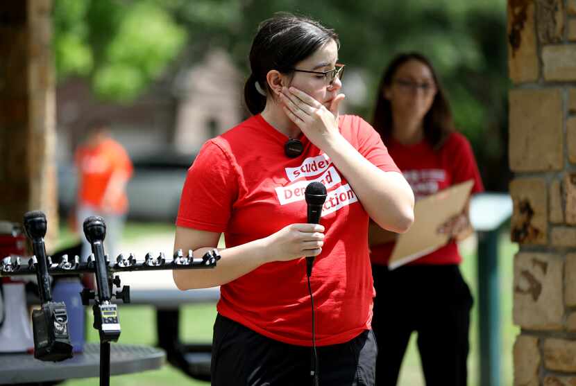 Isabella Spartz wipes away a tear as she speaks during an event to honor and remember the...