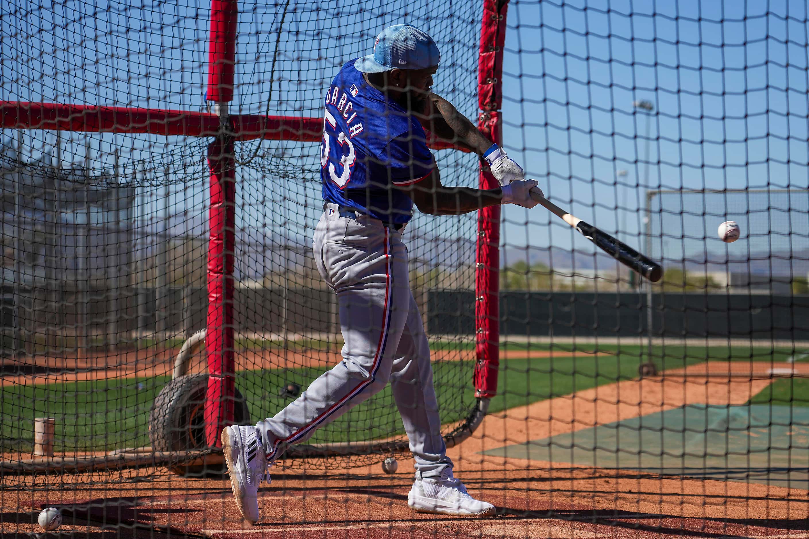 Texas Rangers outfielder Adolis García takes batting practice during the first full squad...