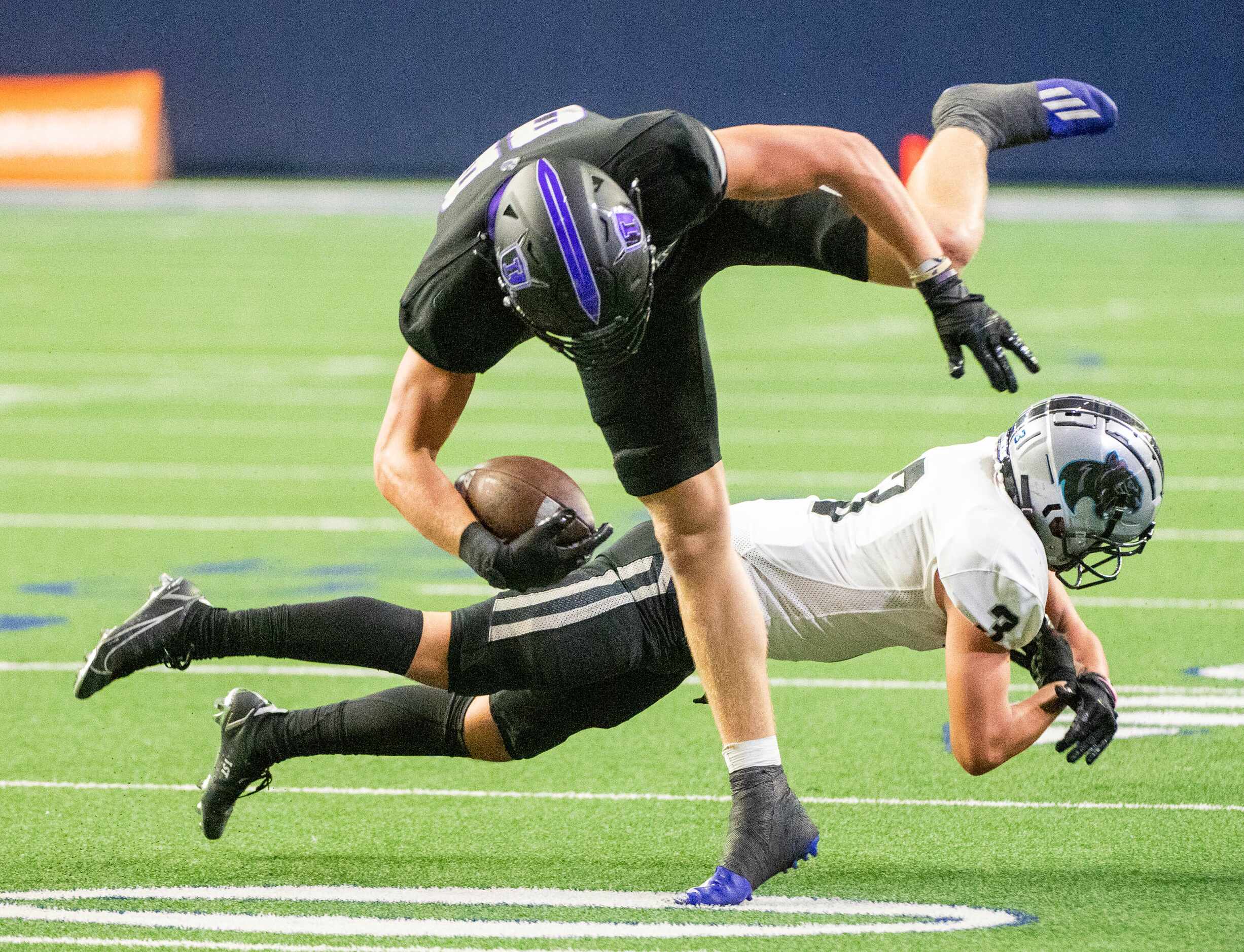 Independence’s Jake Simpson (88) is tripped up by Panther Creek’s Seth Jackson (3) in the...