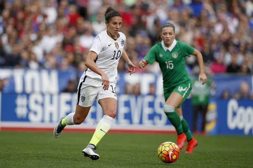 SAN DIEGO, CA - JANUARY 23:  Carli Lloyd #10 of the United States is defended by Katie...