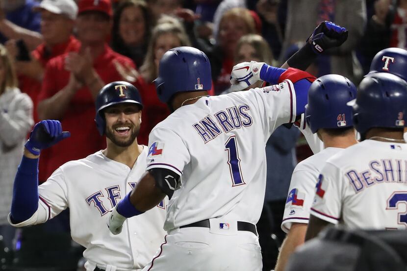 ARLINGTON, TEXAS - APRIL 12:  Elvis Andrus #1 of the Texas Rangers celebrates a three-run...