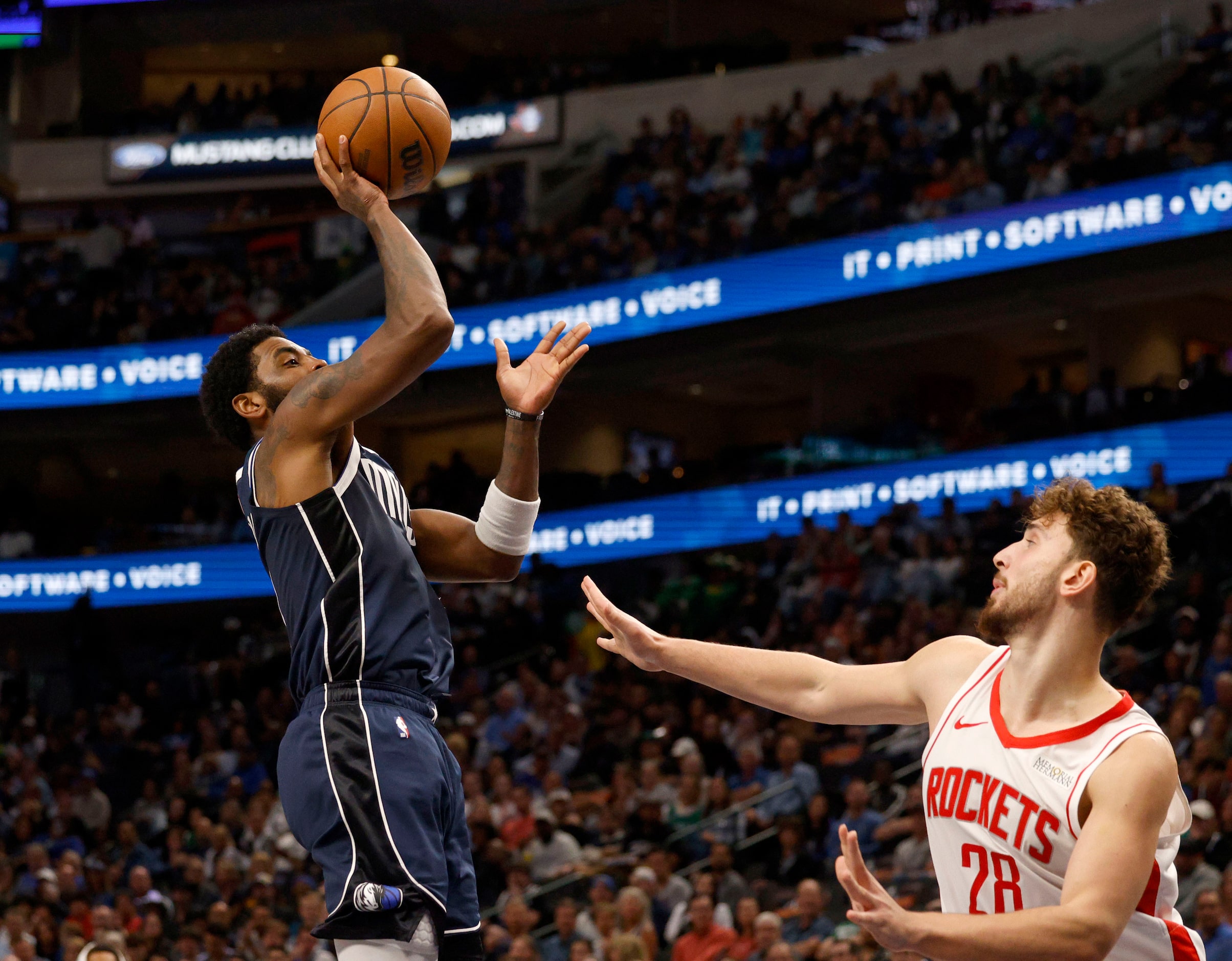 Dallas Mavericks guard Kyrie Irving (11) shoots over Houston Rockets center Alperen Sengun...