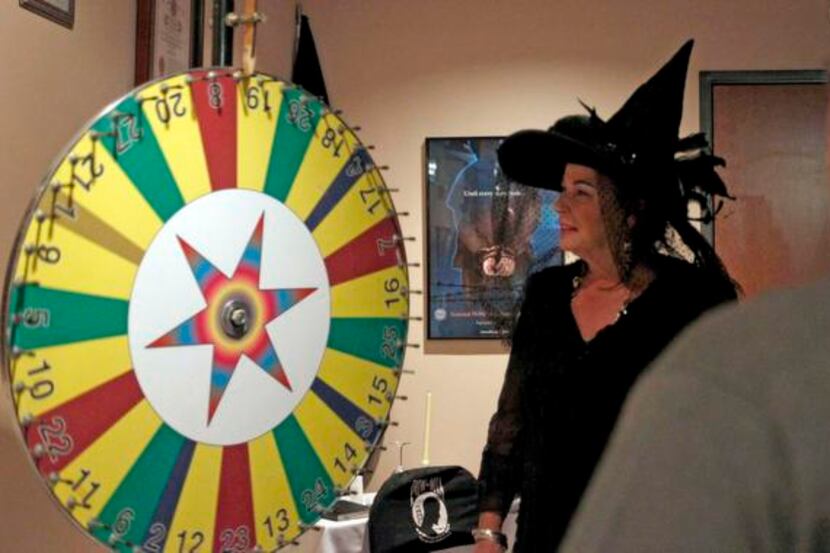 
Denise Paul (left) spins the wheel while Chris Gallucci bets on a color during the VFW Post...