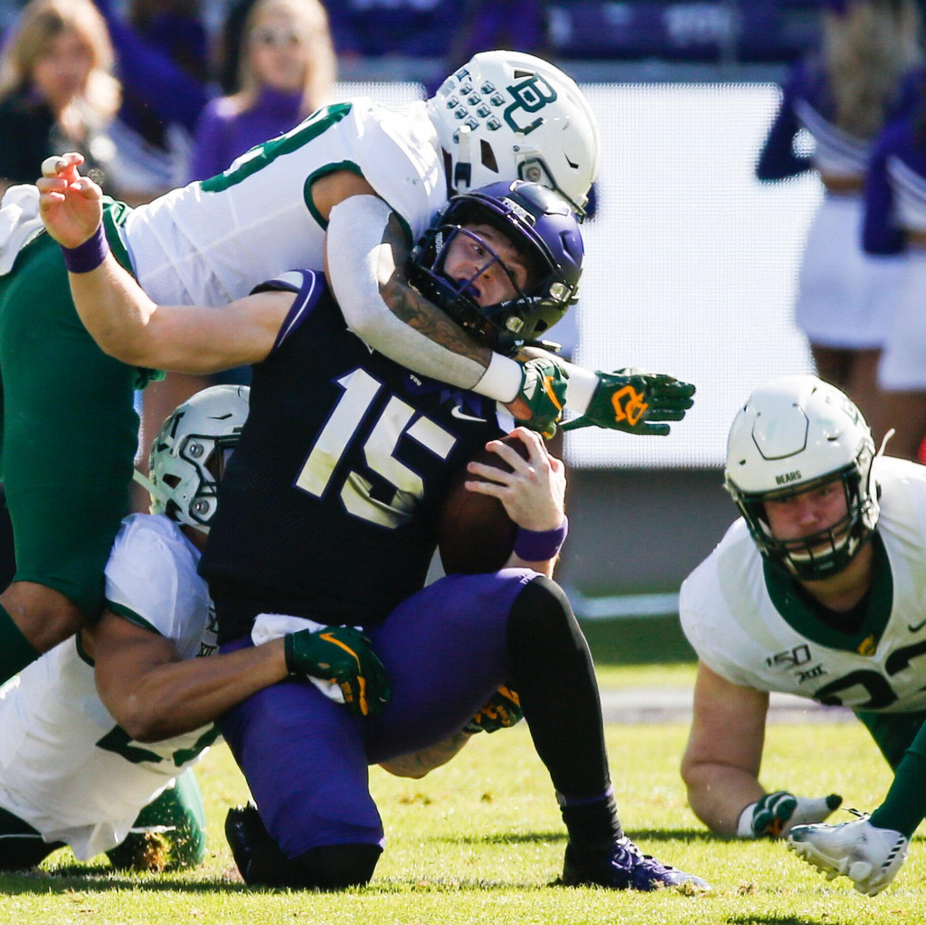 TCU Horned Frogs quarterback Max Duggan (15) is brought down by a swarm of Baylor Bears...