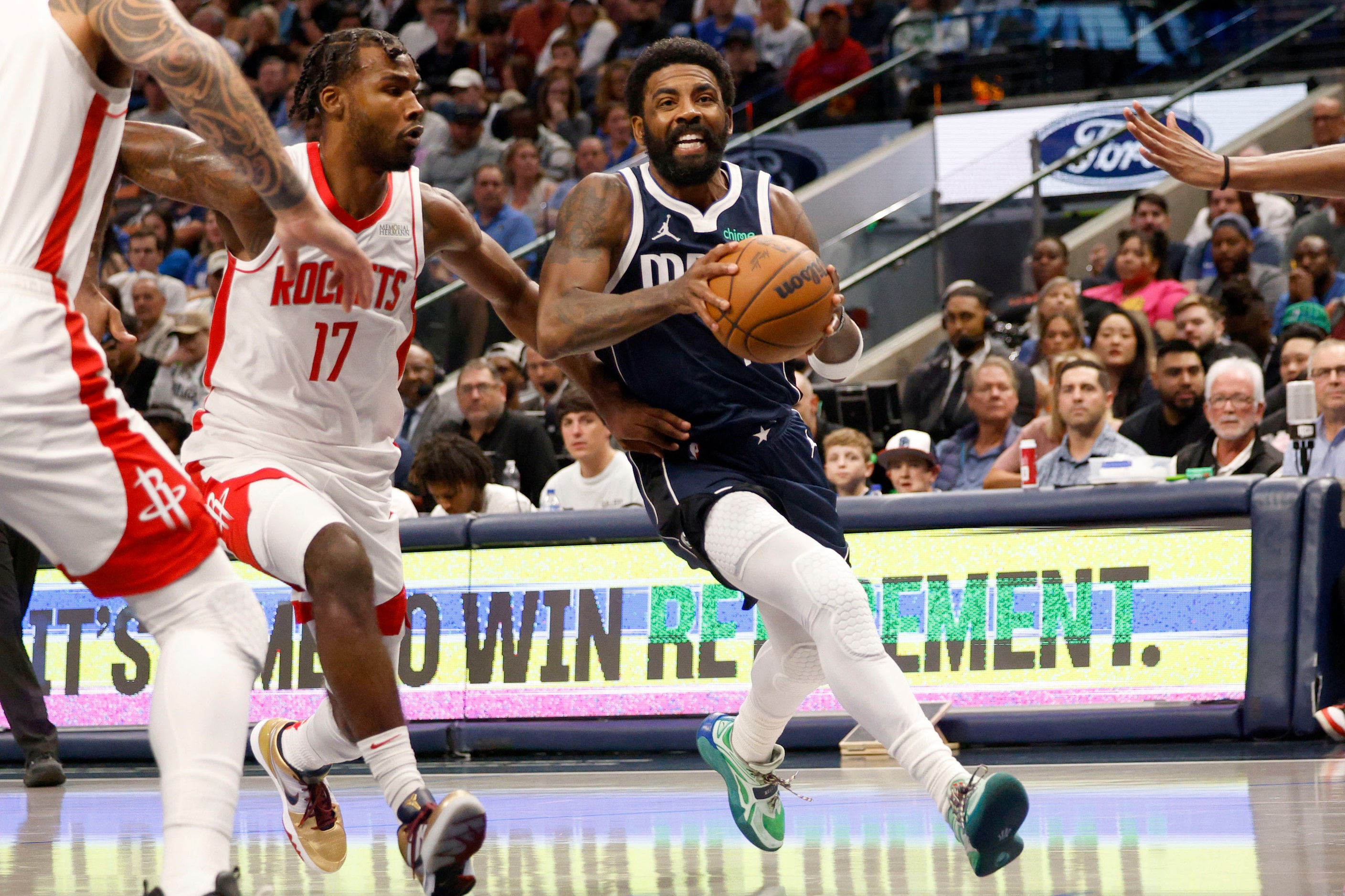 Dallas Mavericks guard Kyrie Irving (11) keeps the ball away from Houston Rockets forward...