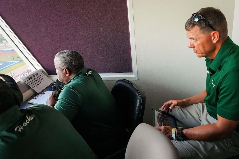 Waxahachie’s Micah Fletcher (right) monitors the team’s video stream on a tablet in the...