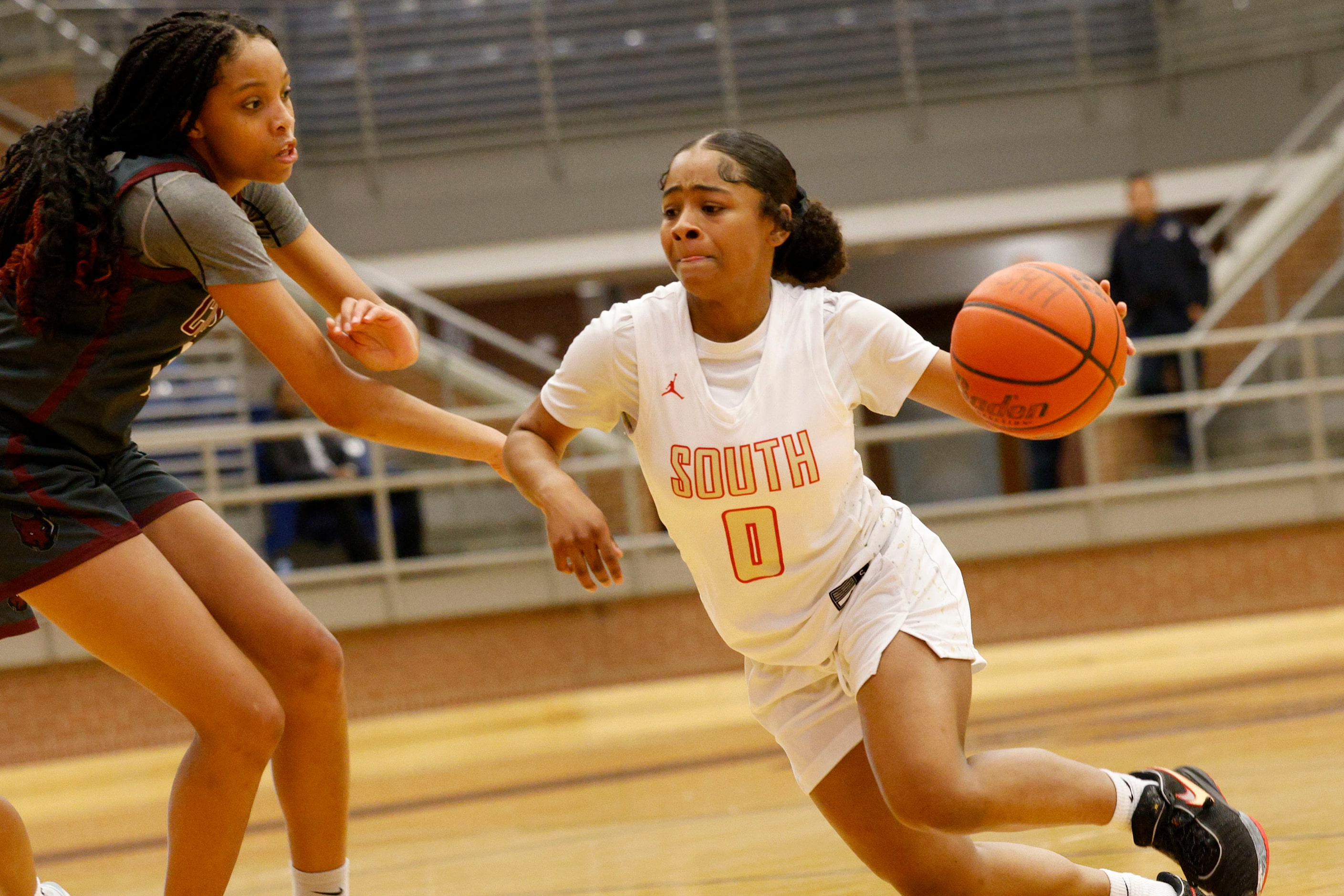 South Grand Prairie's Autumn Sherman (0) tries to drive past Frisco Heritage's Danielle...