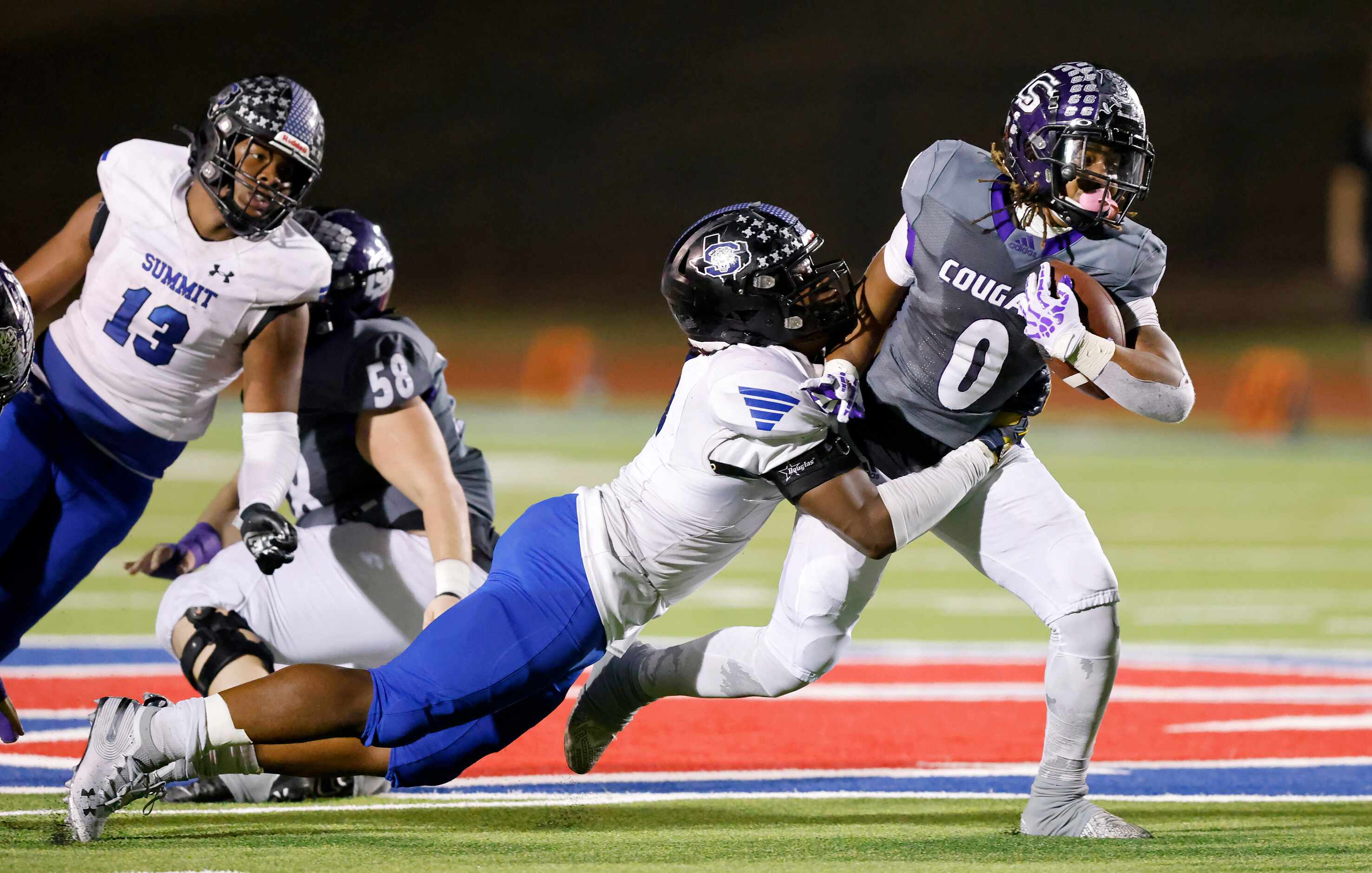 Mansfield Summit  defensive back Joseph Adedire (4) makes a diving tackle of College Station...
