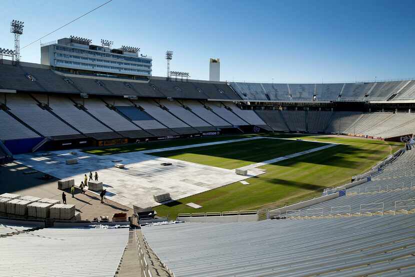 The plastic decking is going down on the Cotton Bowl field in preparation for the New Year's...