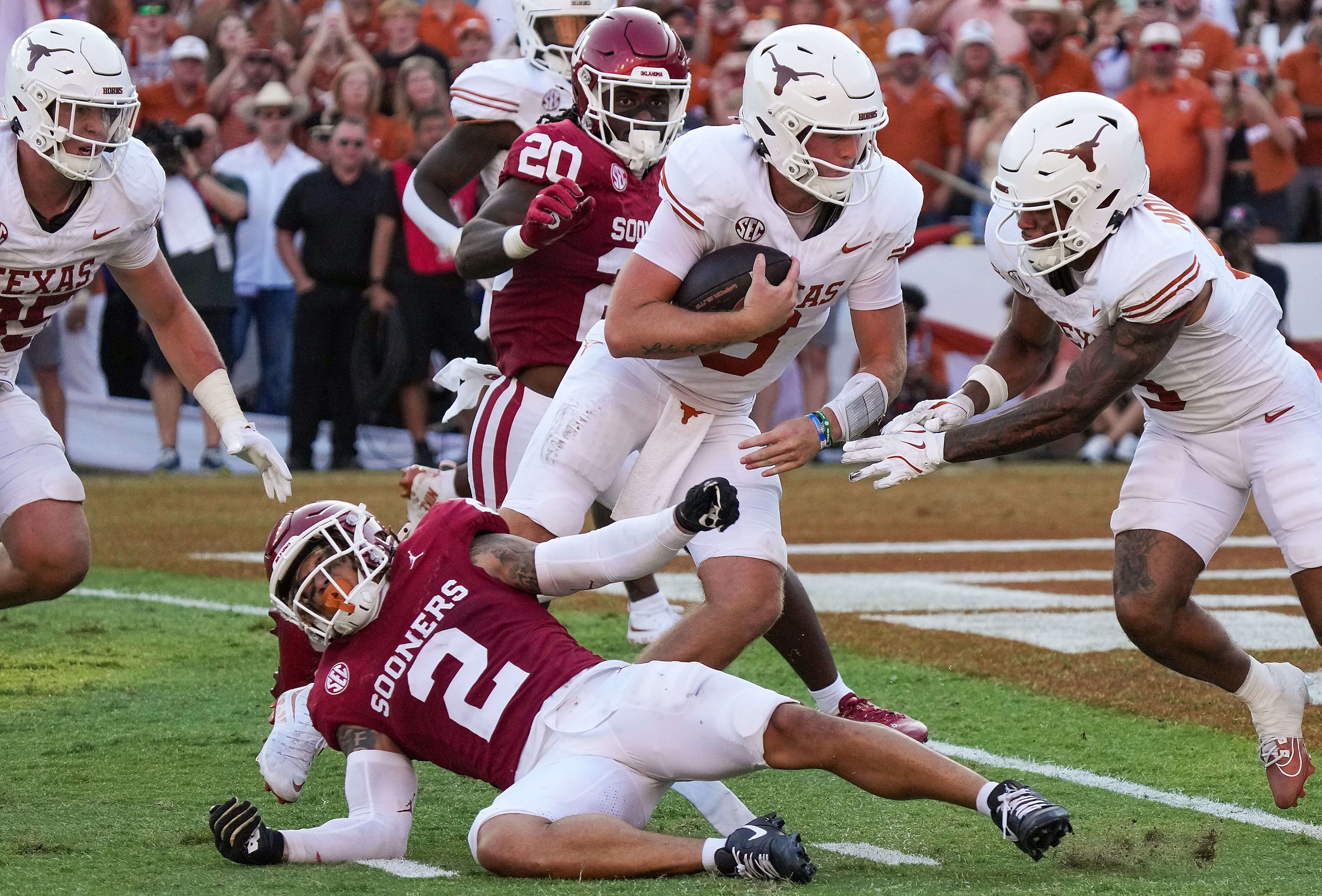 Texas quarterback Quinn Ewers (3) scores on a 1-yard touchdown run past Oklahoma defensive...