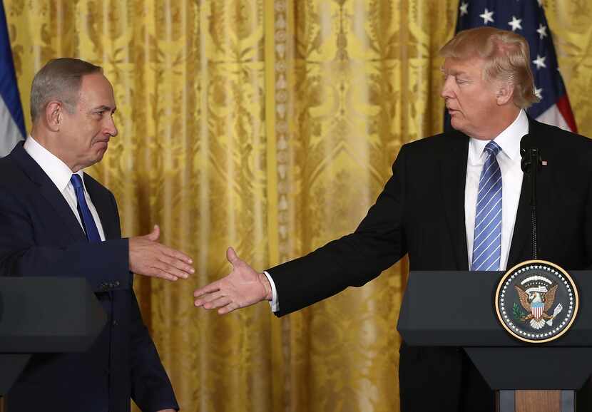 President Trump and Israel Prime Minister Benjamin Netanyahu shake hands following a joint...
