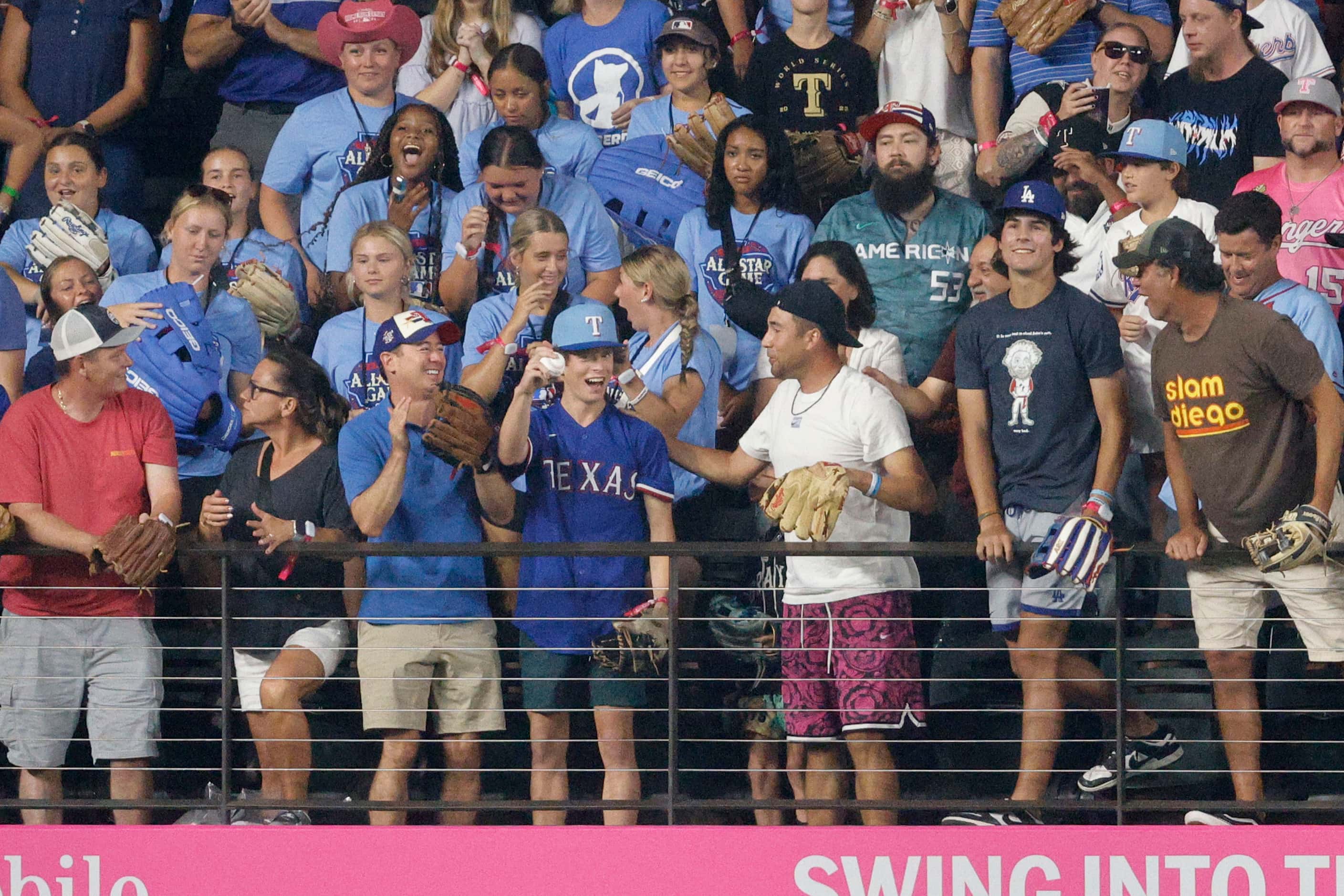 A fan shows a ball after he caught a ball hit by Alec Bohm of Philadelphia Phillies (28)...
