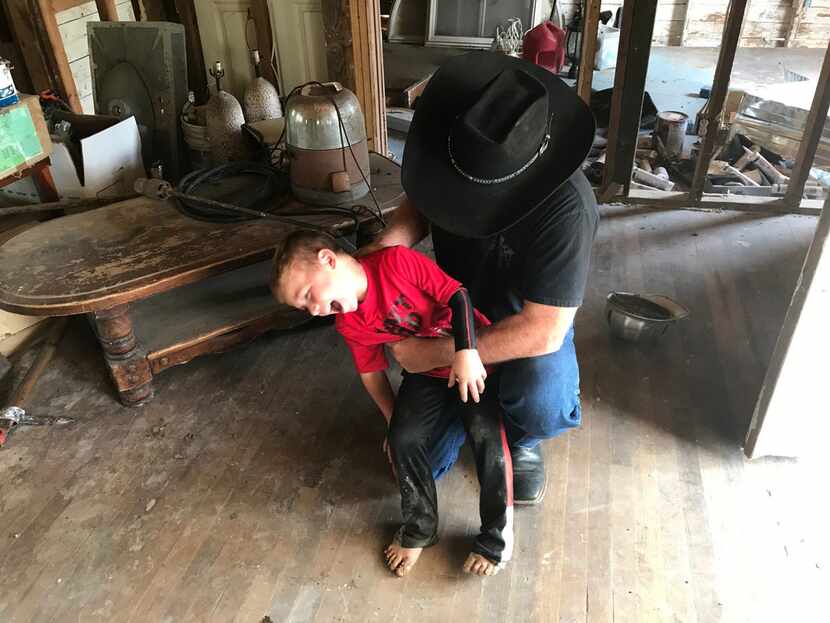 Chris Ward tickles his son, 6-year-old Ryland Ward, at the family home he and his brother...