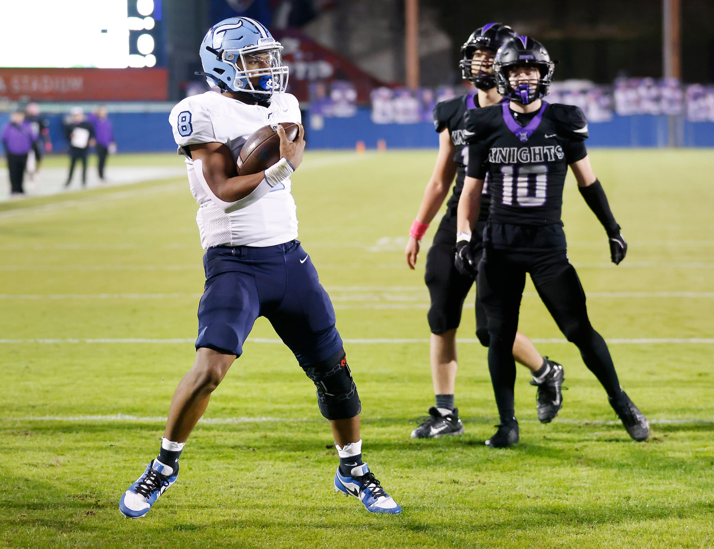 Frisco Emerson running back Kameron Lockhart (8) bounces off a pair of Frisco Independence...