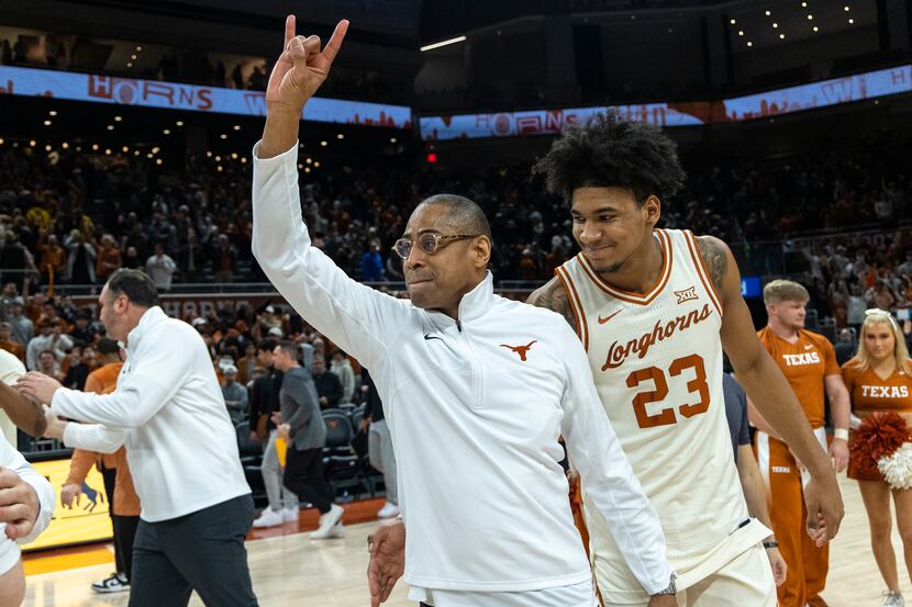 Texas interim head coach Rodney Terry and forward Dillon Mitchell (23) celebrate a win...