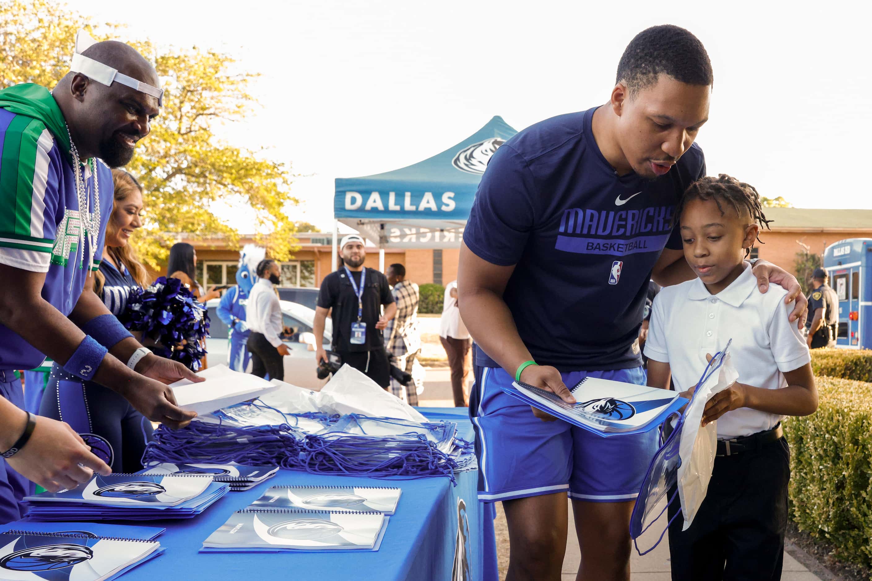 Dallas Mavericks forward Grant Williams hands Ma’khi Hollywood, 9, school supplies during...