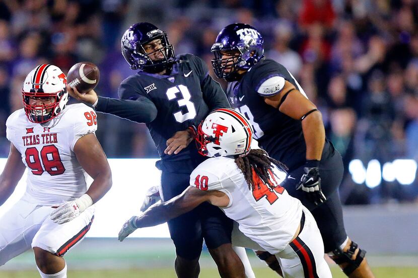 TCU Horned Frogs quarterback Shawn Robinson (3) throws a desperation pass as he's hit by...