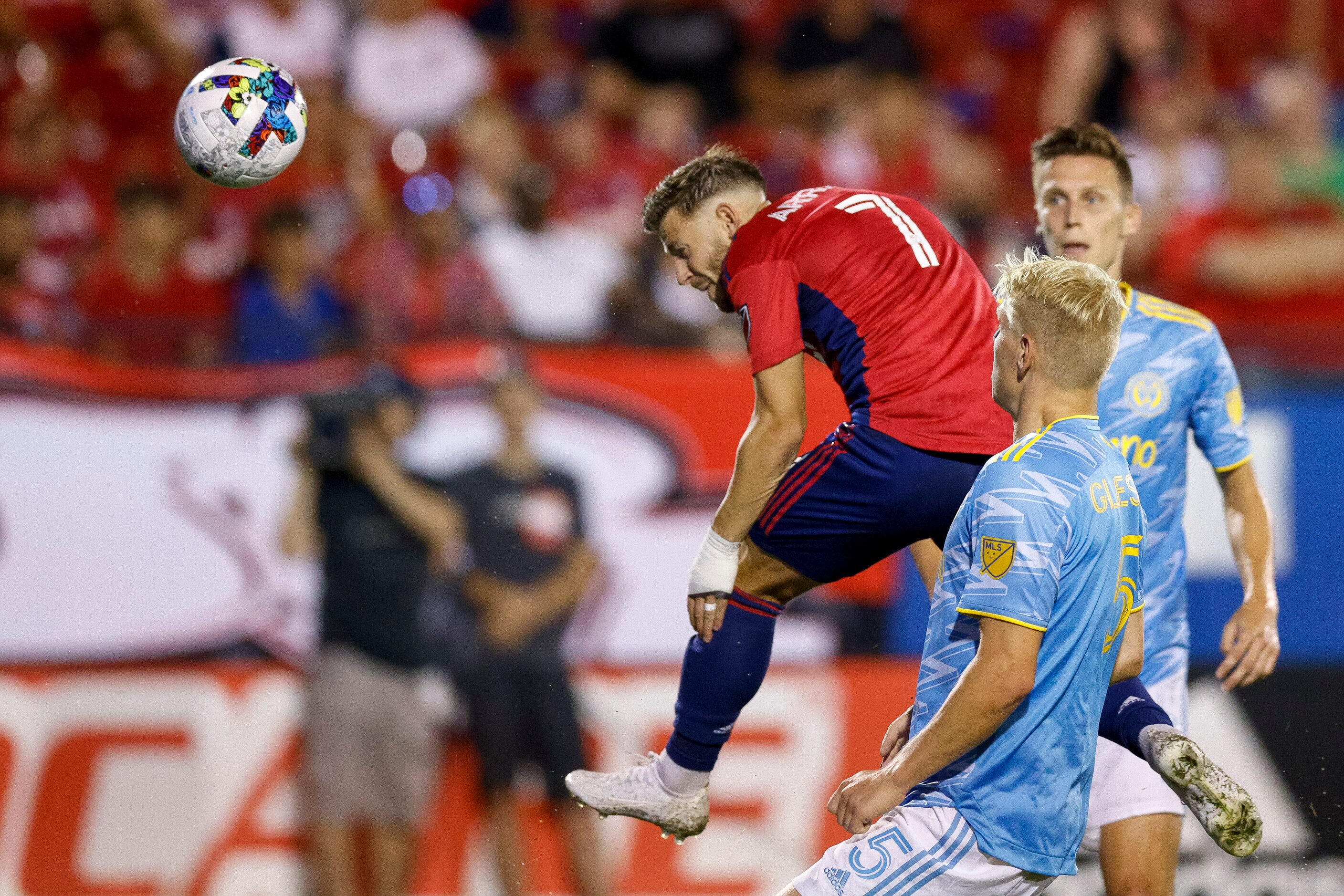 FC Dallas forward Paul Arriola (7) heads the ball towards goal ahead of Philadelphia Union...