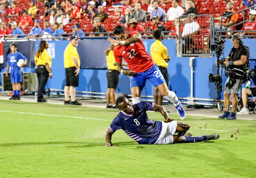Bryan Oviedo of Bermuda tackles Costa Rica's Ronald Matarrita in the 2019 Gold Cup at Toyota...