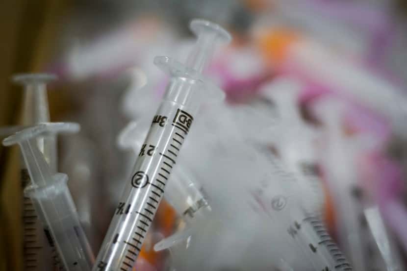Bins of syringes sit ready for COVID-19 vaccine to be administered at Fair Park on Monday,...