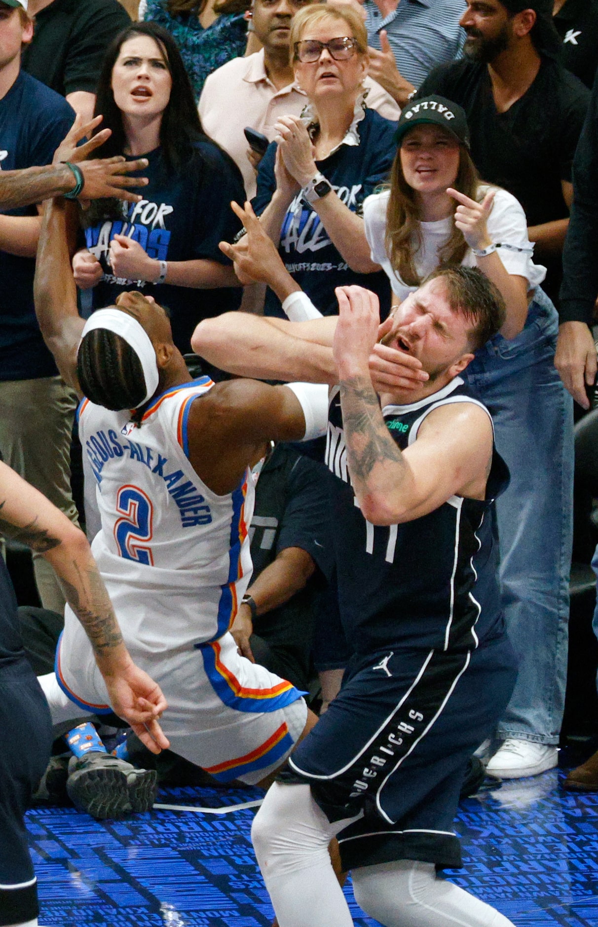 Dallas Mavericks guard Luka Doncic (77) tangles with Oklahoma City Thunder guard Shai...