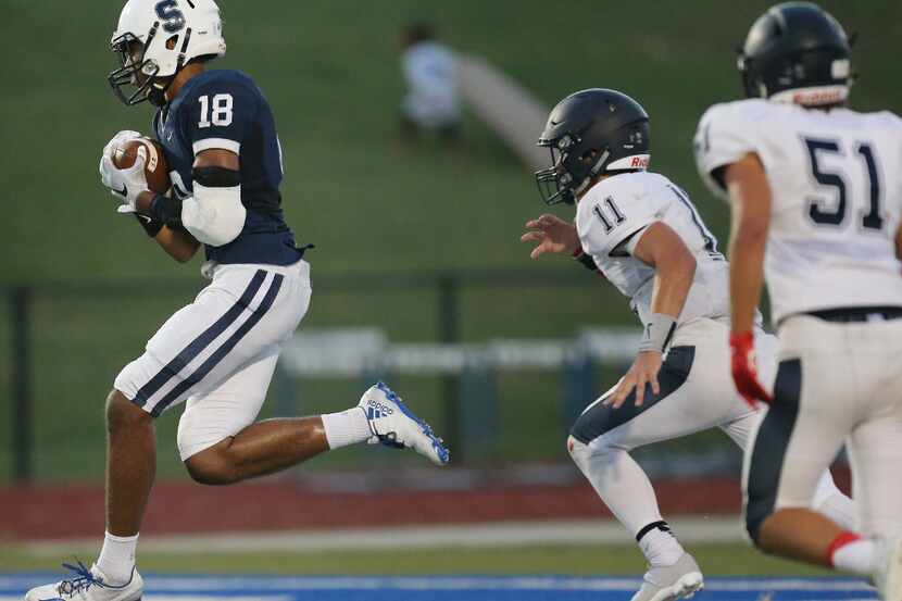 Fort Worth All Saints wide receiver Zadok Scott (18) catches a reception for a touchdown to...