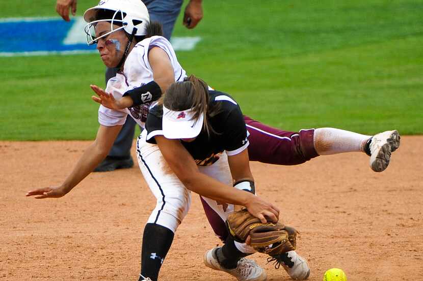 Ennis' Michaela Cochran (1) and Aledo's Rhylie Makawe (11) collide between first and second...