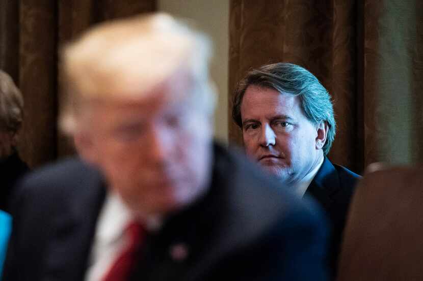 Former White House counsel Donald McGahn, a Federalist Society member, listens to Trump...