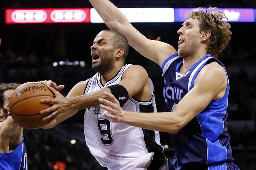 San Antonio Spurs guard Tony Parker (9) splits Dallas Mavericks forward Dirk Nowitzki (41)...