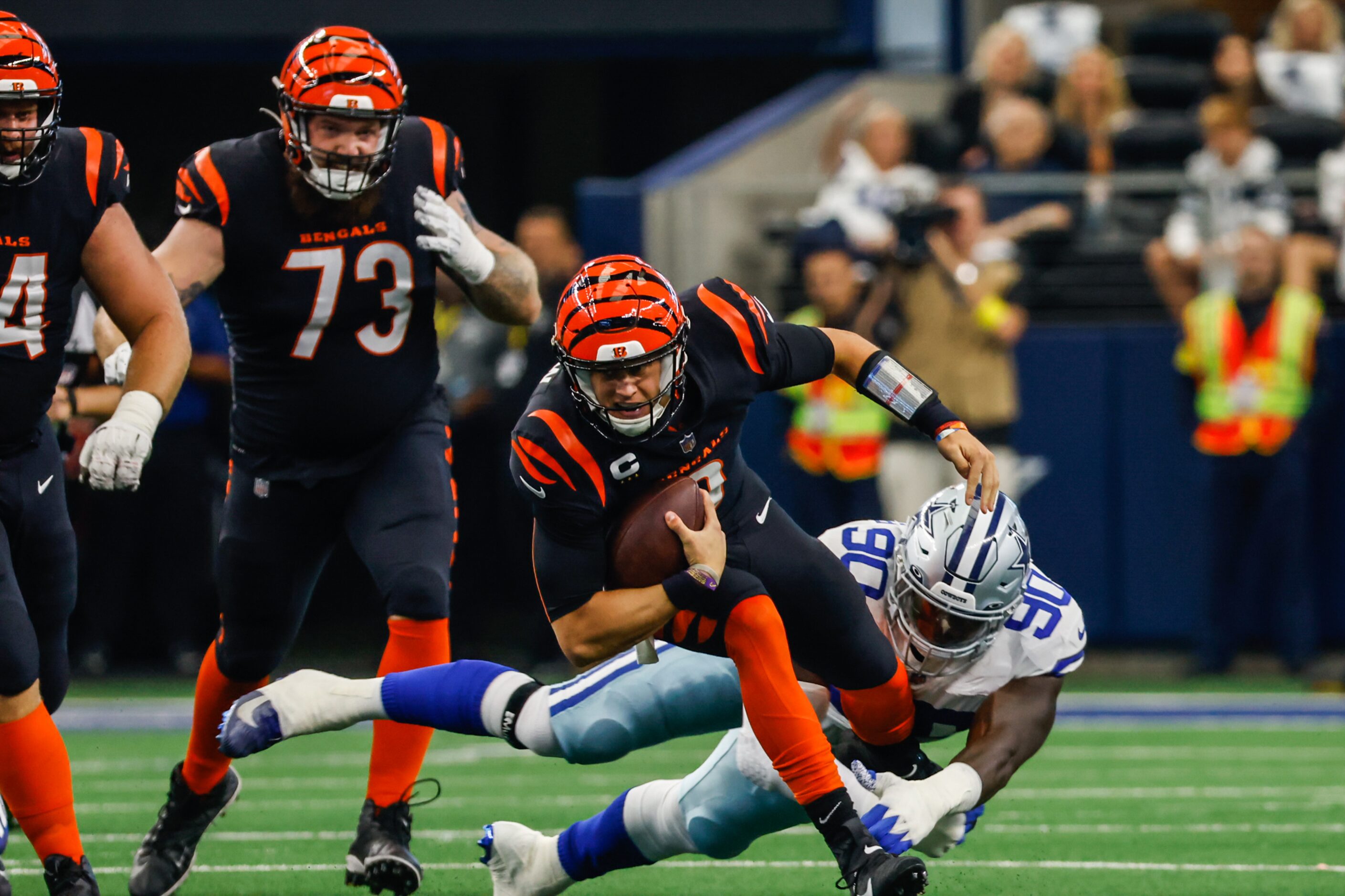 Cincinnati Bengals quarterback Joe Burrow (9) gets tackled by Dallas Cowboys defensive end...