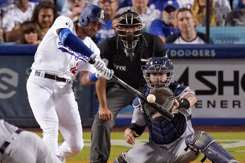 Los Angeles Dodgers' Joey Gallo, second from left, hits a three-run home run while Minnesota...