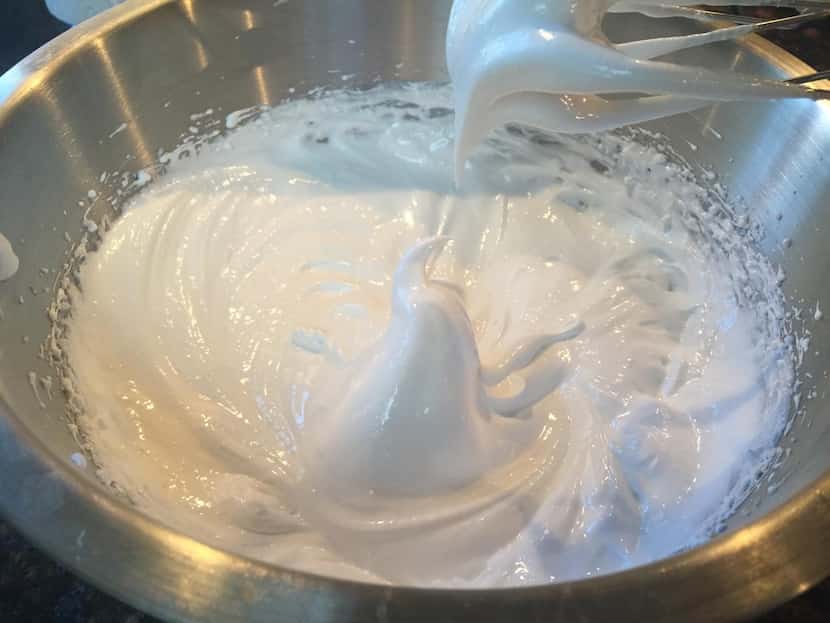 The first step toward preparing a Pavlova shell: Egg whites whipped with sugar until they...