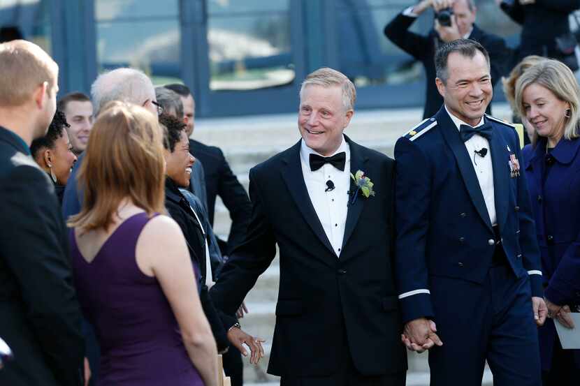 Mark Phariss and Vic Holmes make their way down the aisle during their wedding at the Westin...