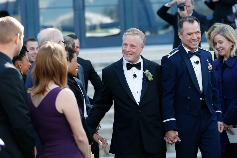 Mark Phariss and Vic Holmes make their way down the aisle during their wedding at the Westin...