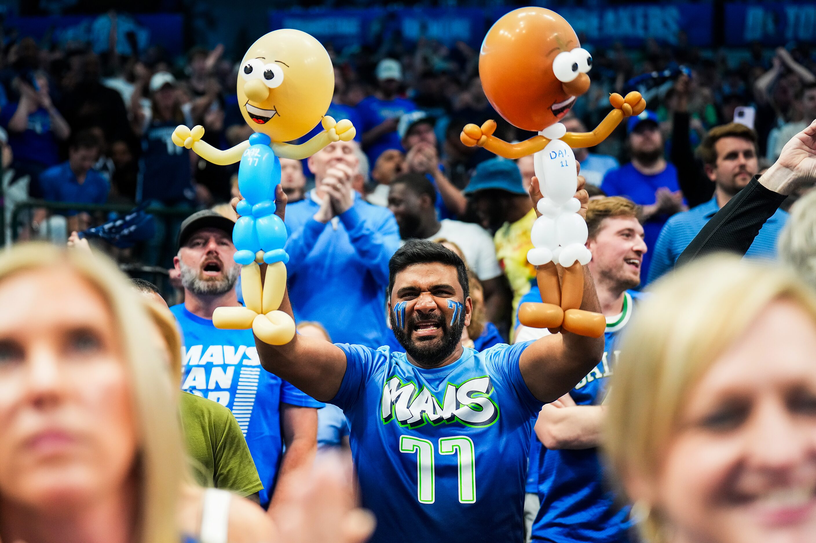 Dallas Mavericks fan Krishna Anne holds balloon representations of Mavericks guard Kyrie...