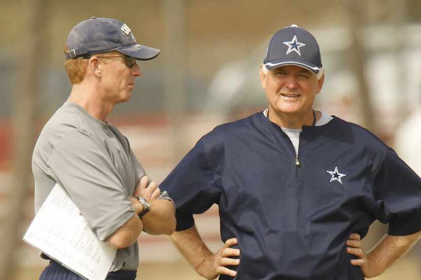 Dallas Cowboys offensive coordinator Jason Garrett, left, talks to head coach Wade Phillips,...