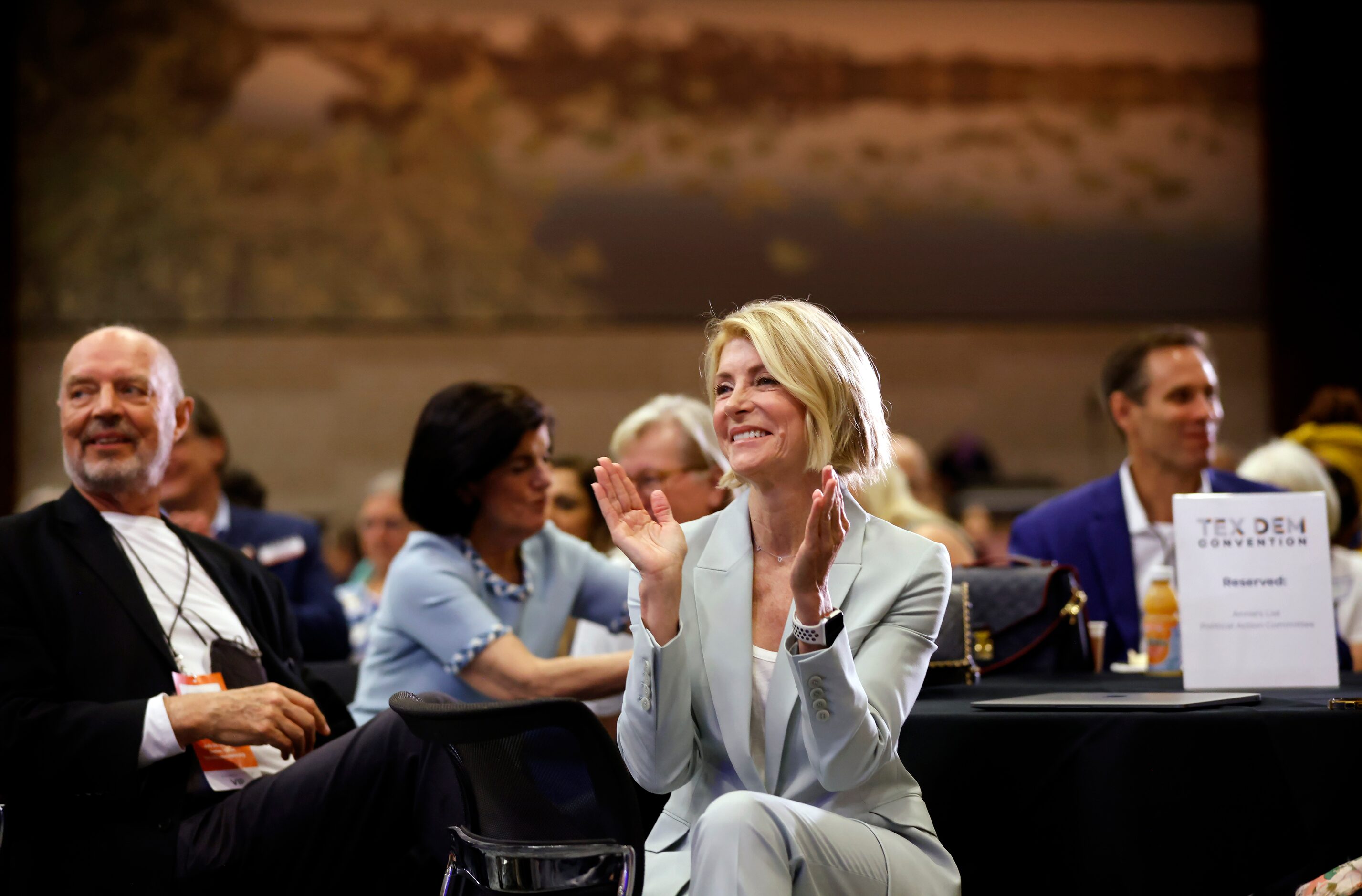 Former Texas State Senator Wendy Davis applauds speaker Julie Johnson before delivering her...