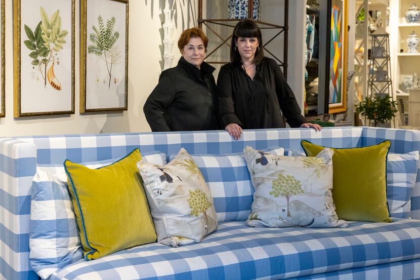Owners Teddie Garrigan (left) and Courtney Garrigan stand with their blue-and-white checked...