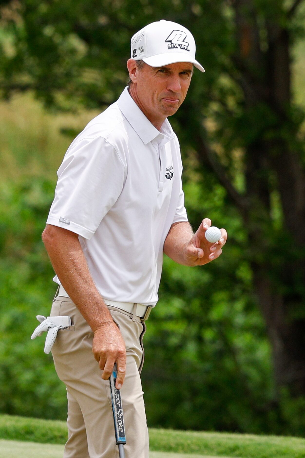 Steven Alker of New Zealand acknowledges the crowd after making birdie on the 18th hole...