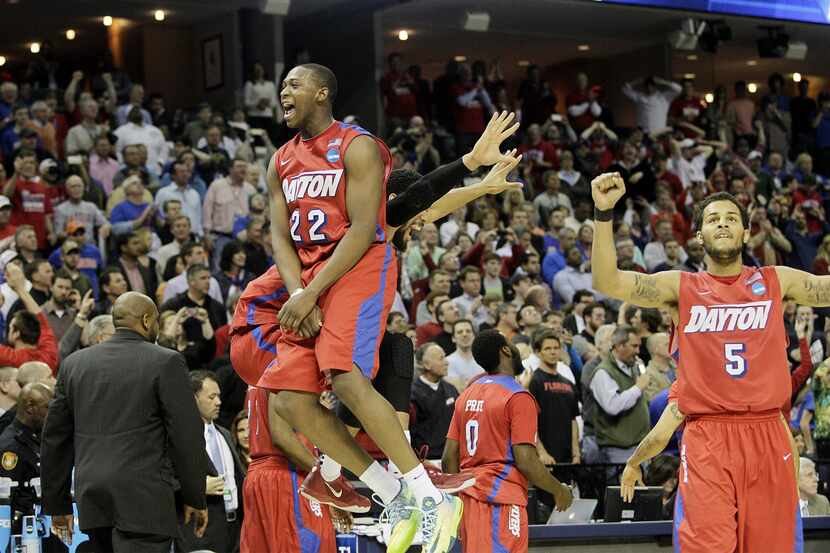 Dayton's Kendall Pollard (22) celebrates with his team at the end of the game in the NCAA...