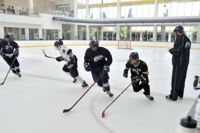 Coach Kevin Bakke ran on-ice drills during tryouts for the McKinney Lightning youth hockey...