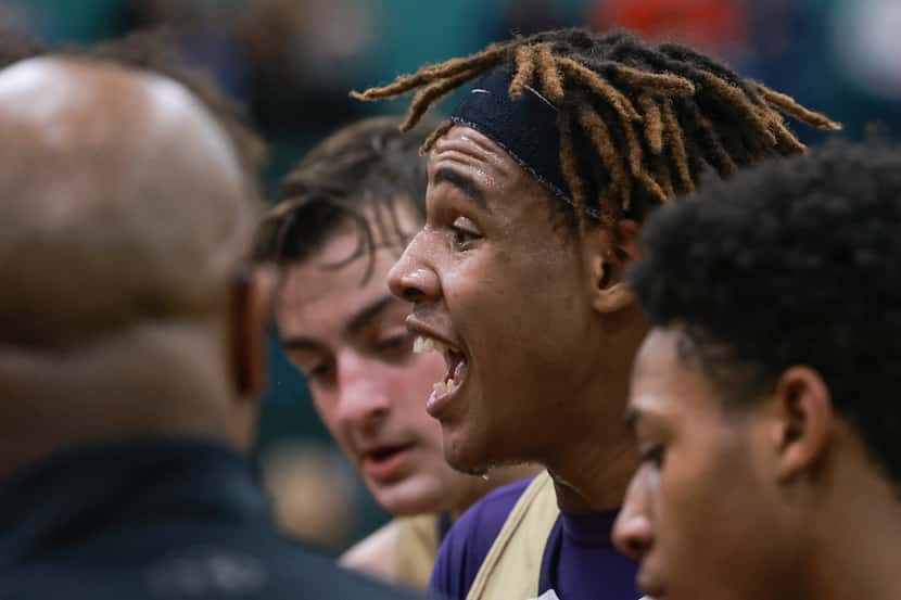 Denton High School’s MJ Thomas (10) talks to his teammates during a break in the game at...