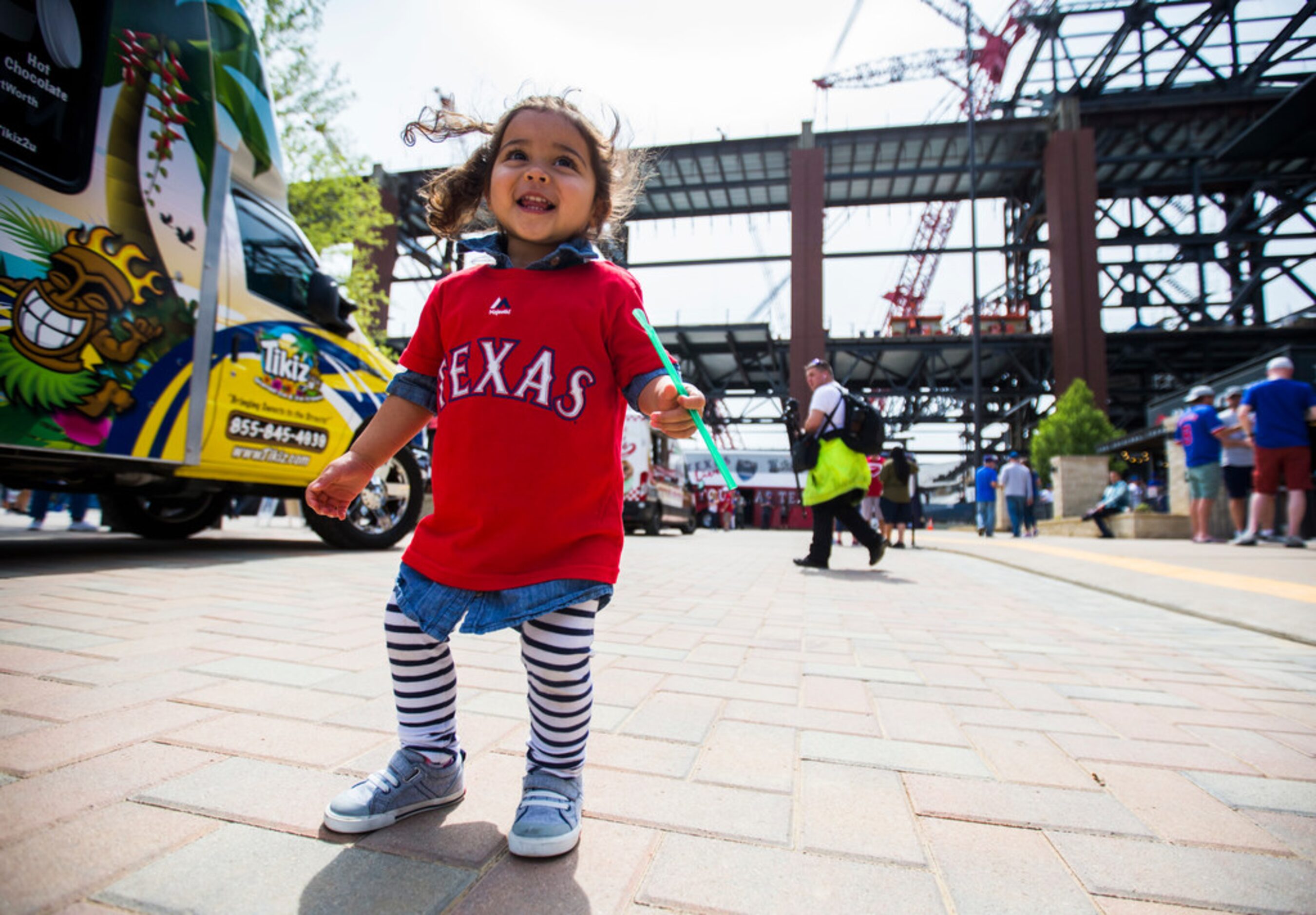 Lila Grace Guerra, 2, of Los Angeles dances as fans celebrate Texas Rangers Opening Day with...