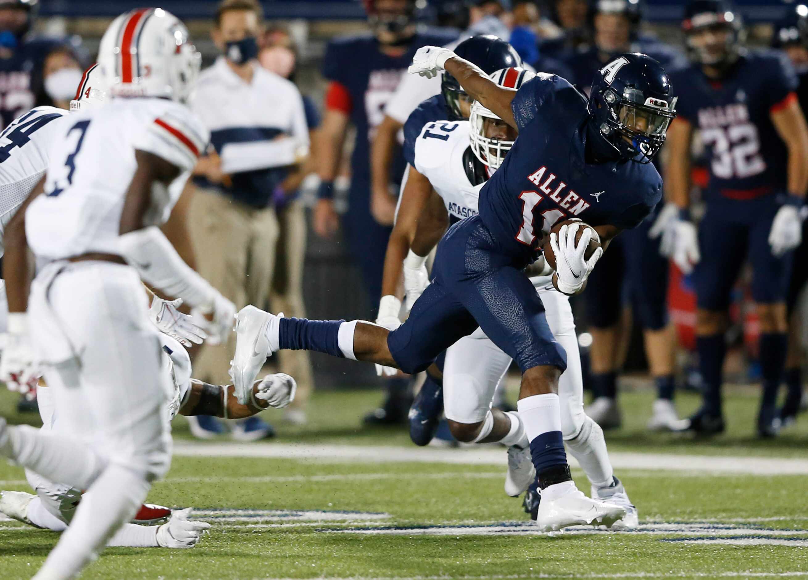 Allen's Jordan Johnson (11) is tripped up by Humble Atascocita's Jordan Augustine (1) on a...
