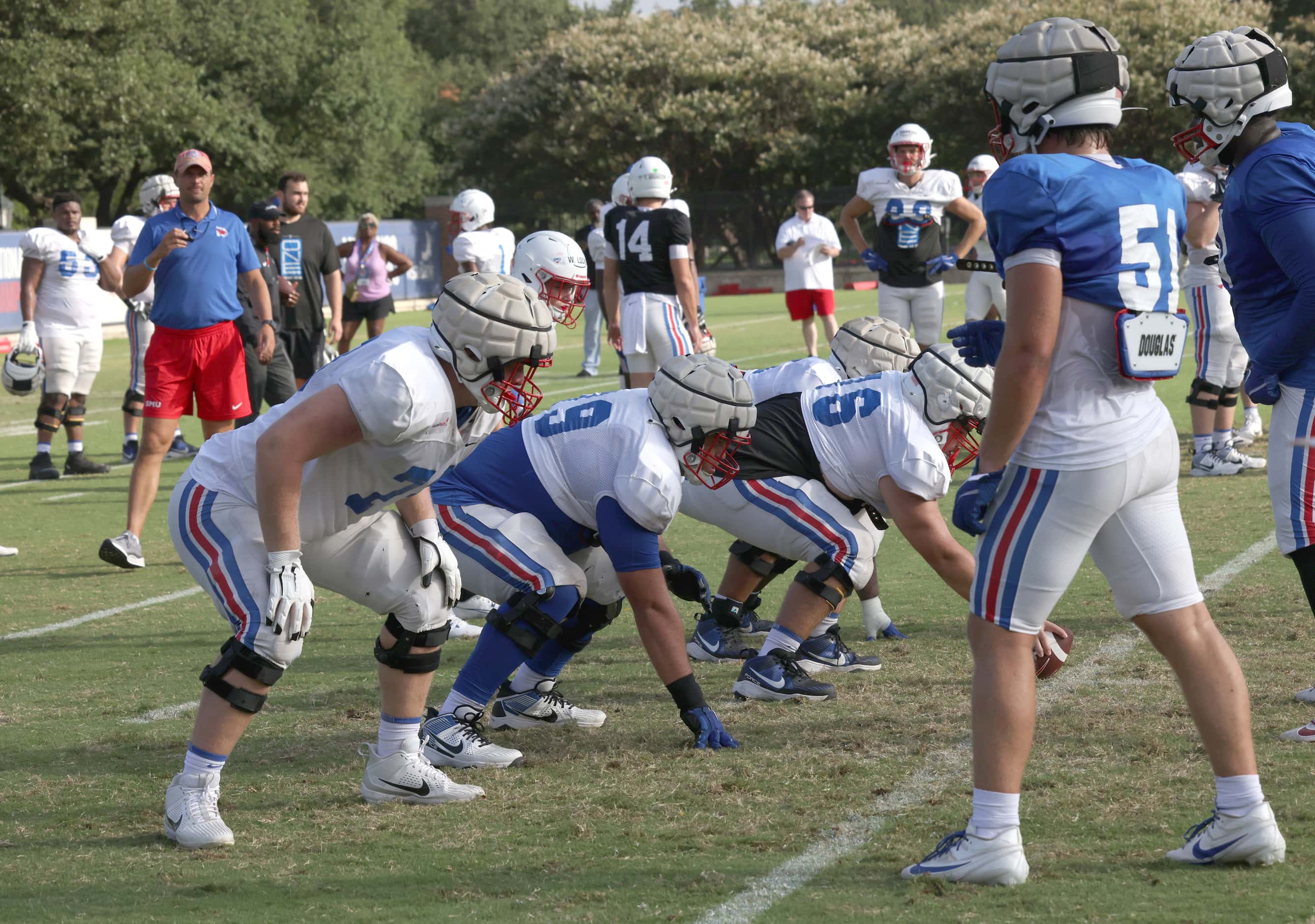 Members of the SMU Mustangs offensive line prepare for a snap during a drill. The Southern...